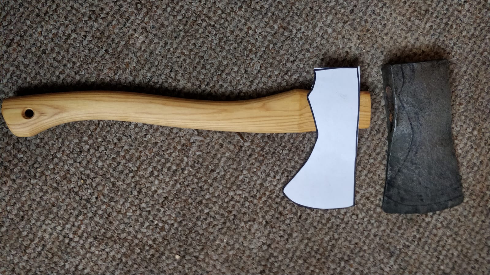 a photo of an ugly axe head and a handle that's too small