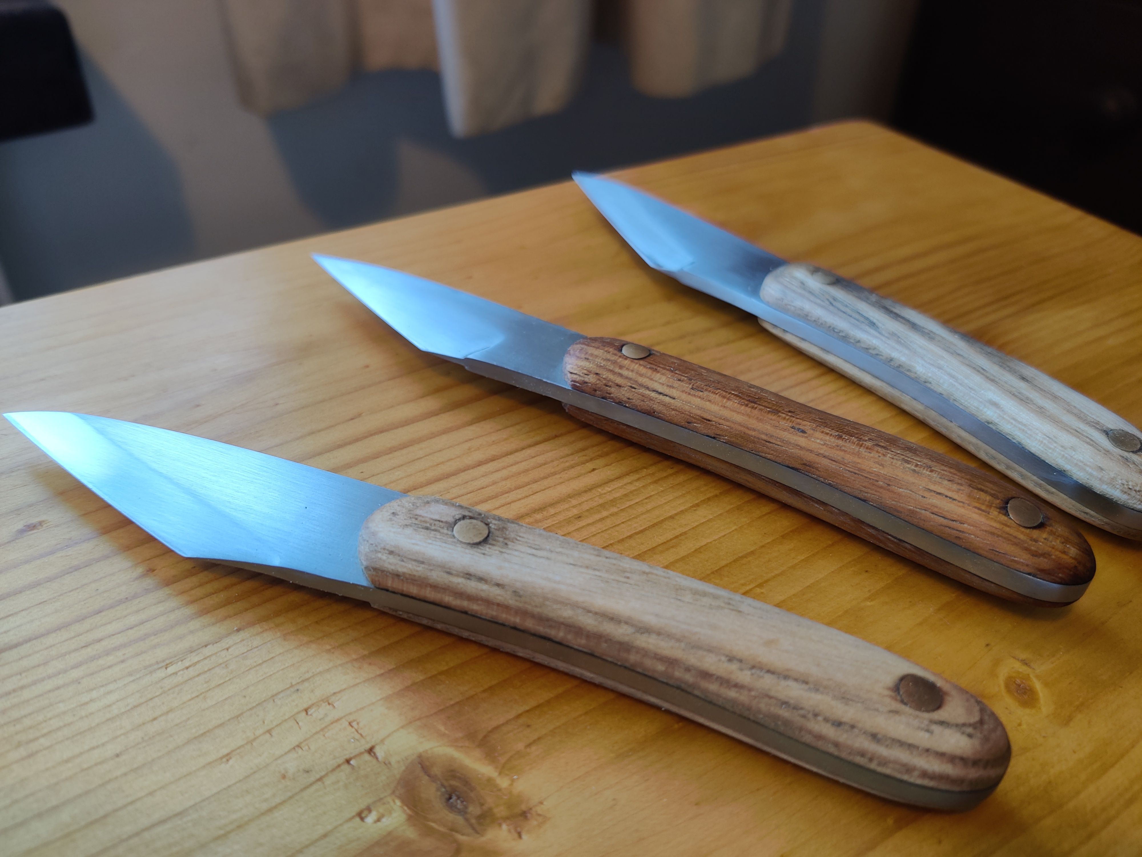 a photo of 3 finished knives