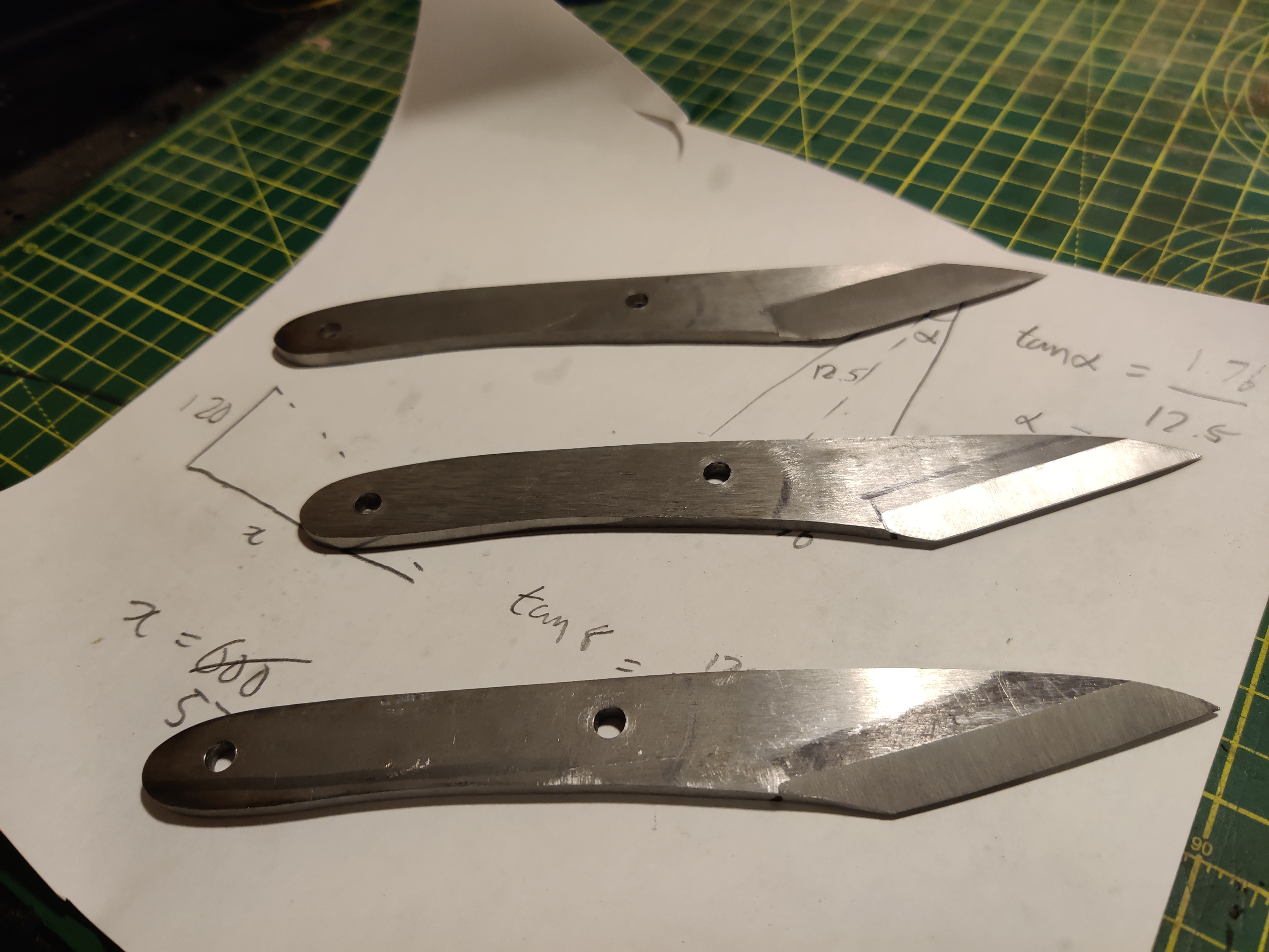 a photo of 3 unfinished knives