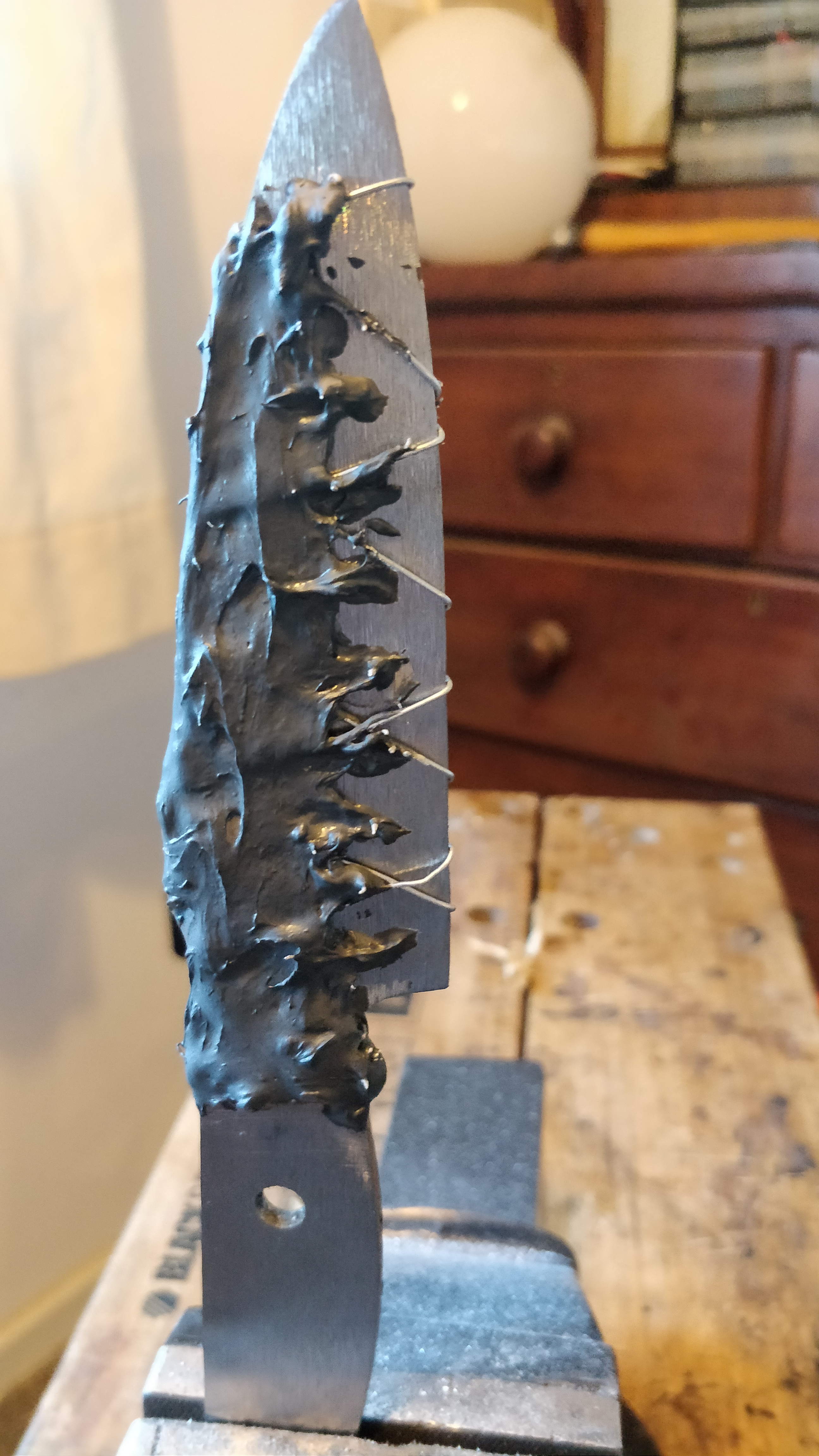 a photo of a knife covered in wire and schmoo