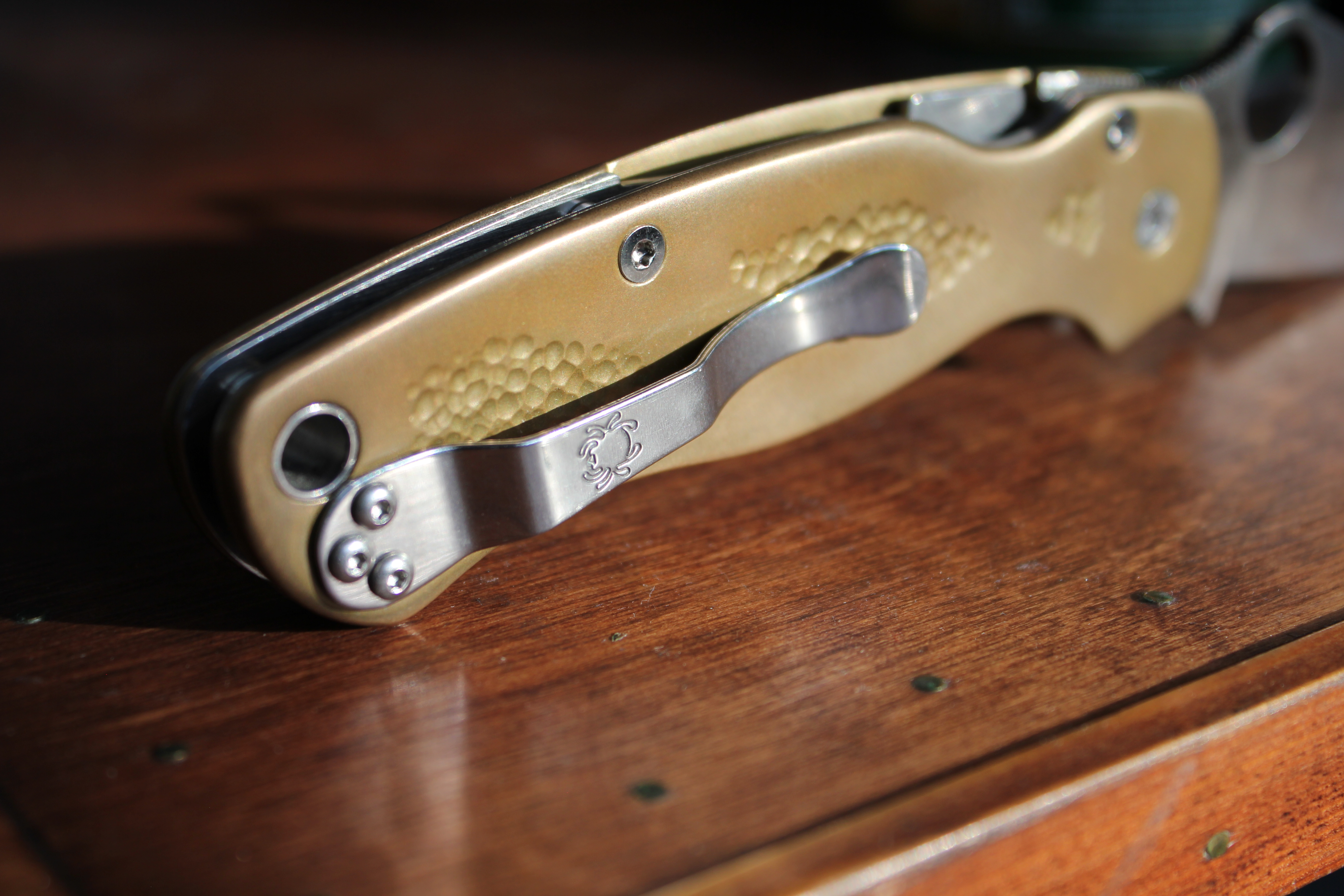 an image of the back of a knife with some brass scales